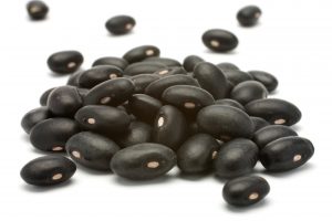 a small handful of black beans - preto. beans isolated on a white background. close-up.