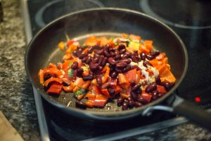 fried red beans and vegetables on a pan